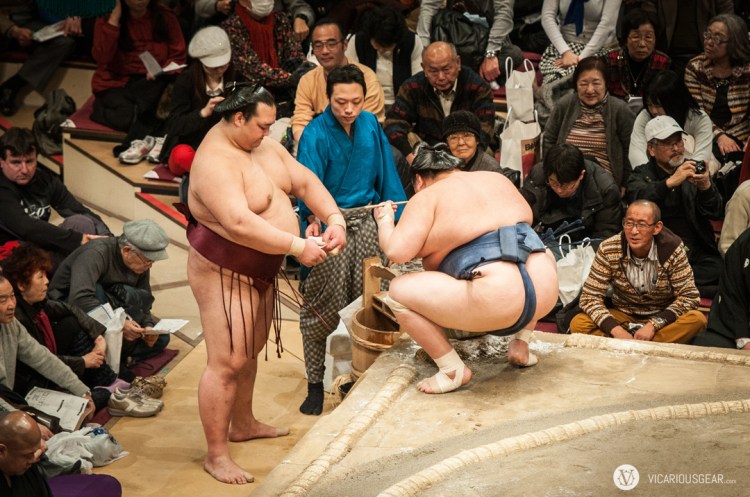 The next wrestler waiting to compete would always offer water to the current competitor as the match started.