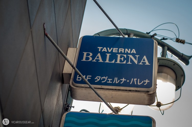 The small sign outside is well offset from the actual entrance and partially obscured by the lamp post.