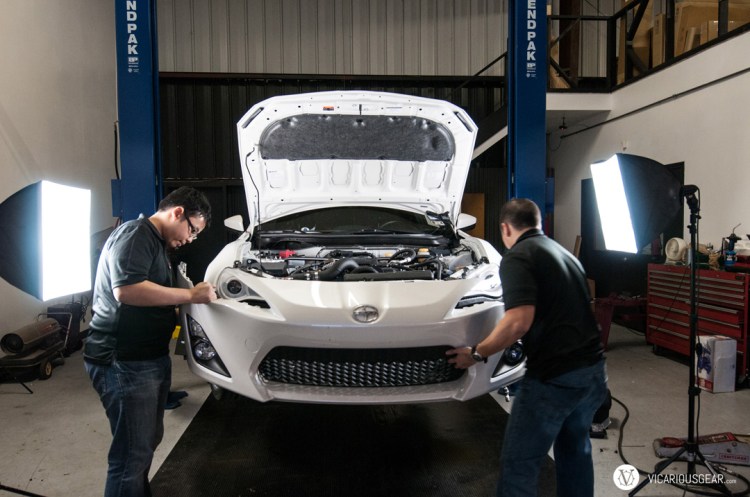 Bumper going back on after all the supercharger components were installed. The clips that hold the top side of the OEM bumper near the headlights and side markers are an even worse design than for the S2000. A bit of a pain with the intercooler pulling everything down.