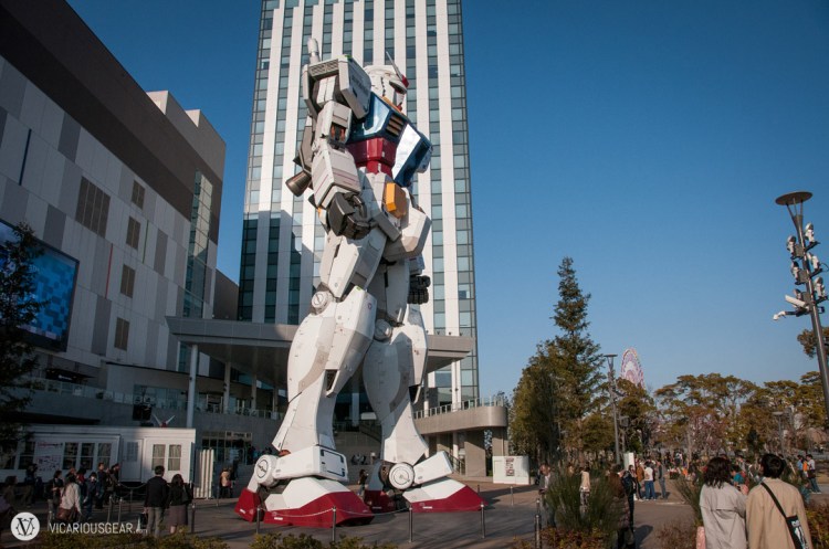 The first view of the huge Gundam as you turn the corner around the mall is from his right side.