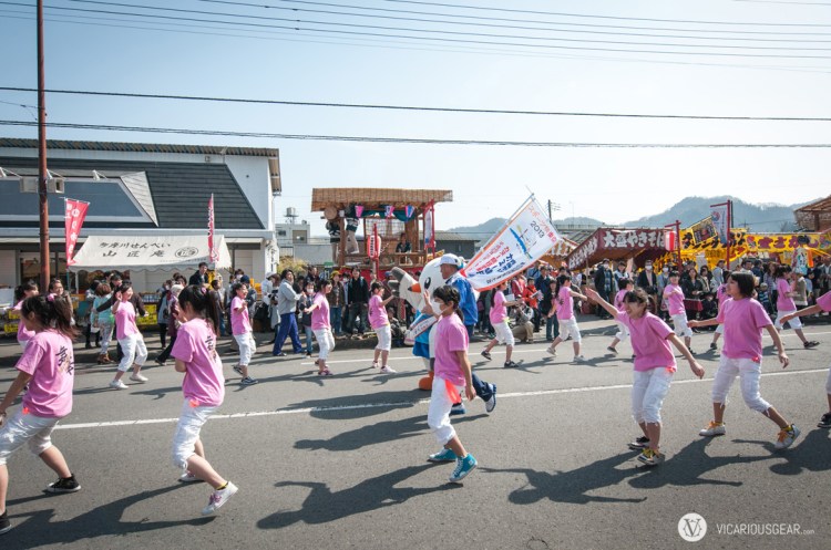 I'm not sure why this bird was being escorted down the street through the dancing kids.