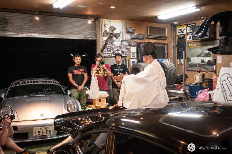 It turns out the priest happens to own the white convertible RWB 993, known as the "Spearmint Rhino." Quite an amusing choice for a guy that runs multiple shrines.