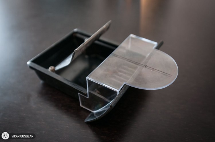 After some trial and error, I was able to reduce the contact points on the inside of the ash tray. The plastic is just flexible enough to slide over the top and clip in under the guide rails.