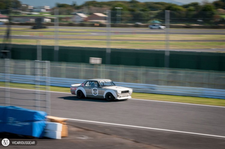 The driver looked over at the grandstand every time he passed.