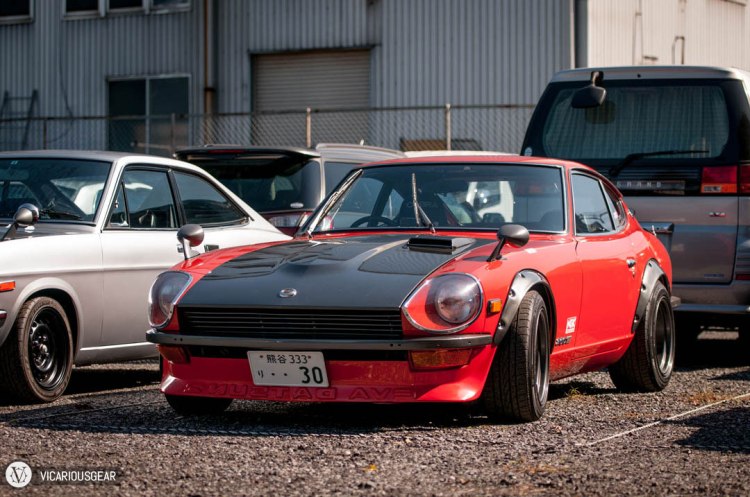 A great looking Fairlady in red sporting an EVA splitter and overfenders.