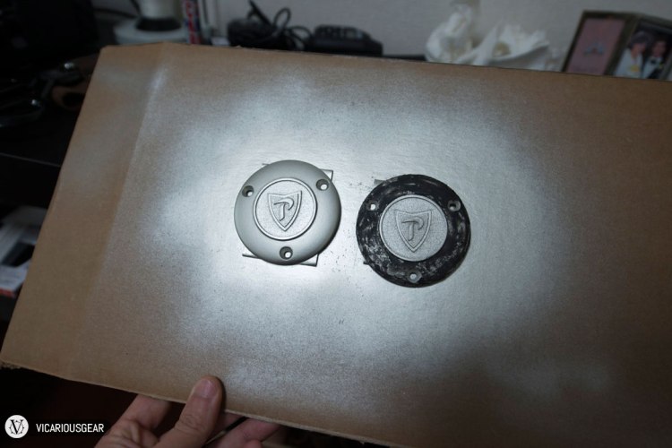 Then once I was happy with the prepared surface, a couple thick coats of paint were applied. Finished surface on the left and cap with rough body filler on the right. I decided to paint this one to match the exterior color of the car.